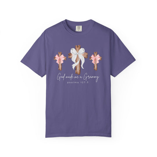 Purple T-shirt with three wooden crosses, center cross larger with white bow, flanked by pink-bowed crosses; text reads “God made me a Grammy,” referencing Psalms 127:3.