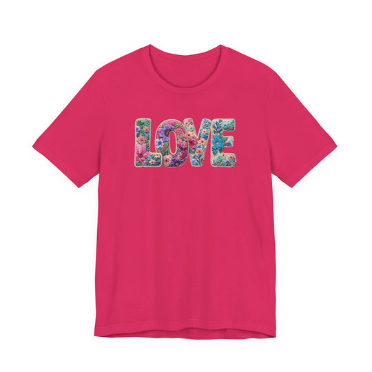 Magenta crew-neck T-shirt with LOVE in floral motif, crafted from soft cotton, offering a classic fit, by Faith Family Designs.