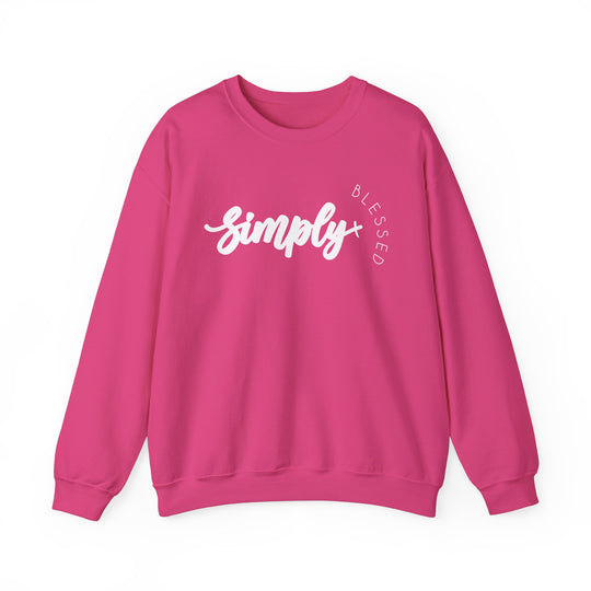 Simply Blessed Crew: A pink unisex sweatshirt featuring white text, designed for comfort with a ribbed knit collar and no side seams, made from a polyester-cotton blend.