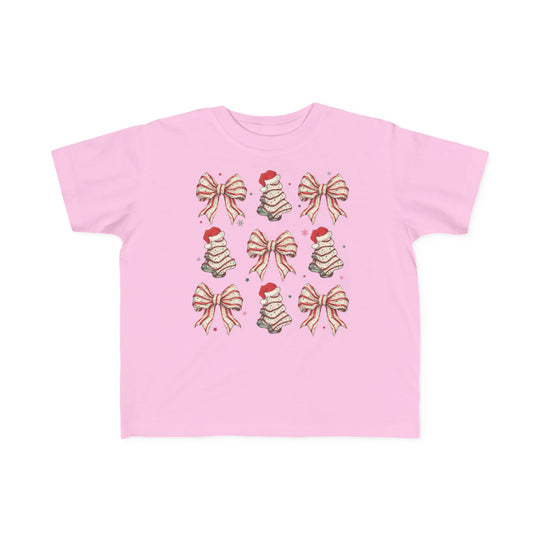Cookies and Bows Toddler Tee: Light pink T-shirt featuring a 3x3 holiday motif pattern with gift-bows and cake-style Christmas trees, ideal for toddlers' comfort and style.