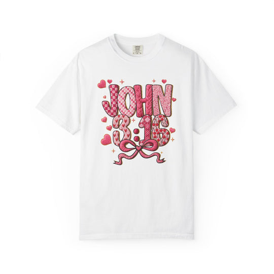 3:16 Tee displaying “JOHN 3:16” in pink-red patterned letters with hearts, sparkles, and a bow on a white short-sleeve T-shirt.