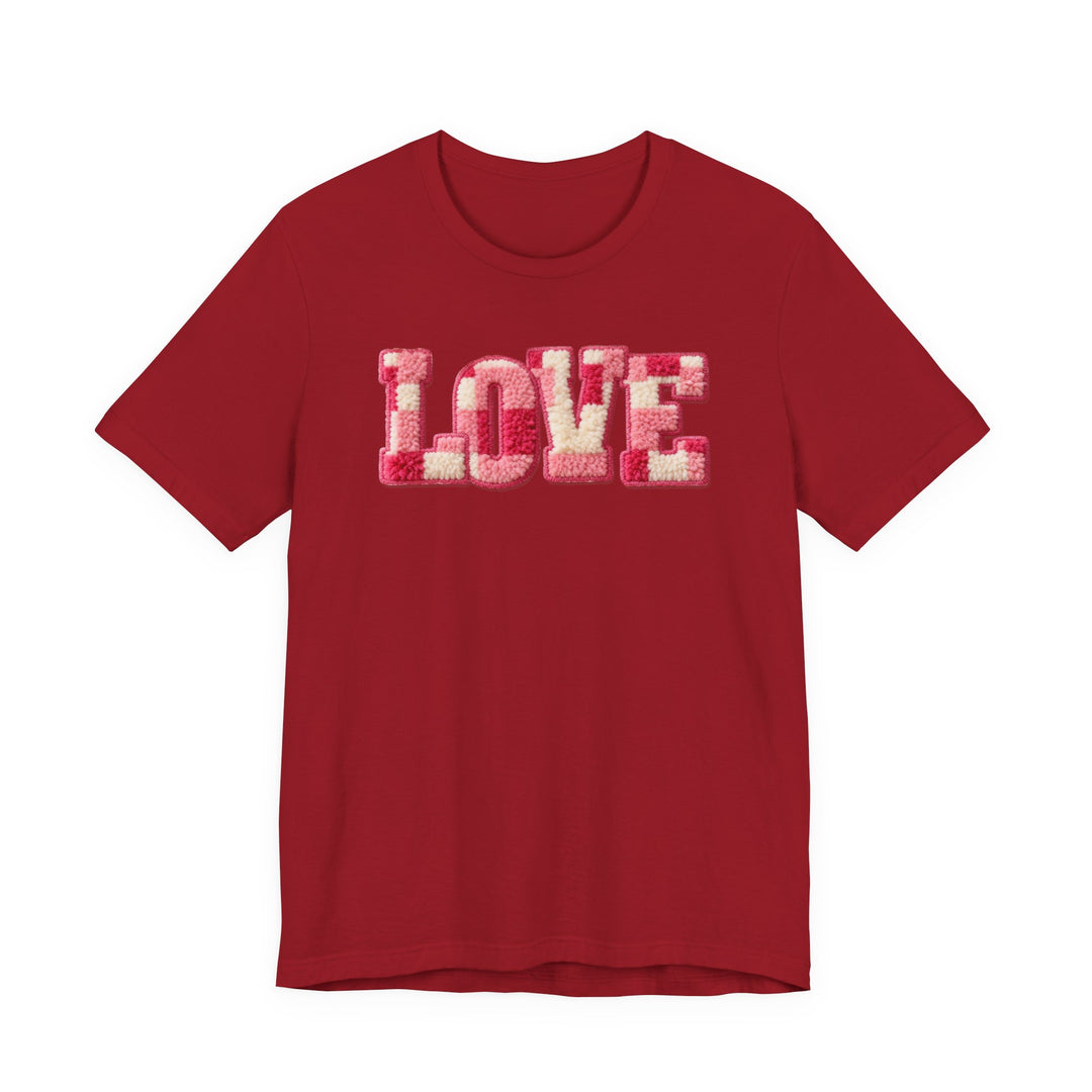 Red Love Tee with LOVE in pink and cream tufted letters, short-sleeved, unisex fit, soft cotton, ribbed collar, taping for durability.