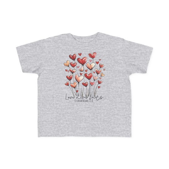 Love Never Fails Toddler Tee: Light heather gray with heart-shaped blooms and Love never fails script, perfect soft fit for toddlers, 100% cotton, classic style.