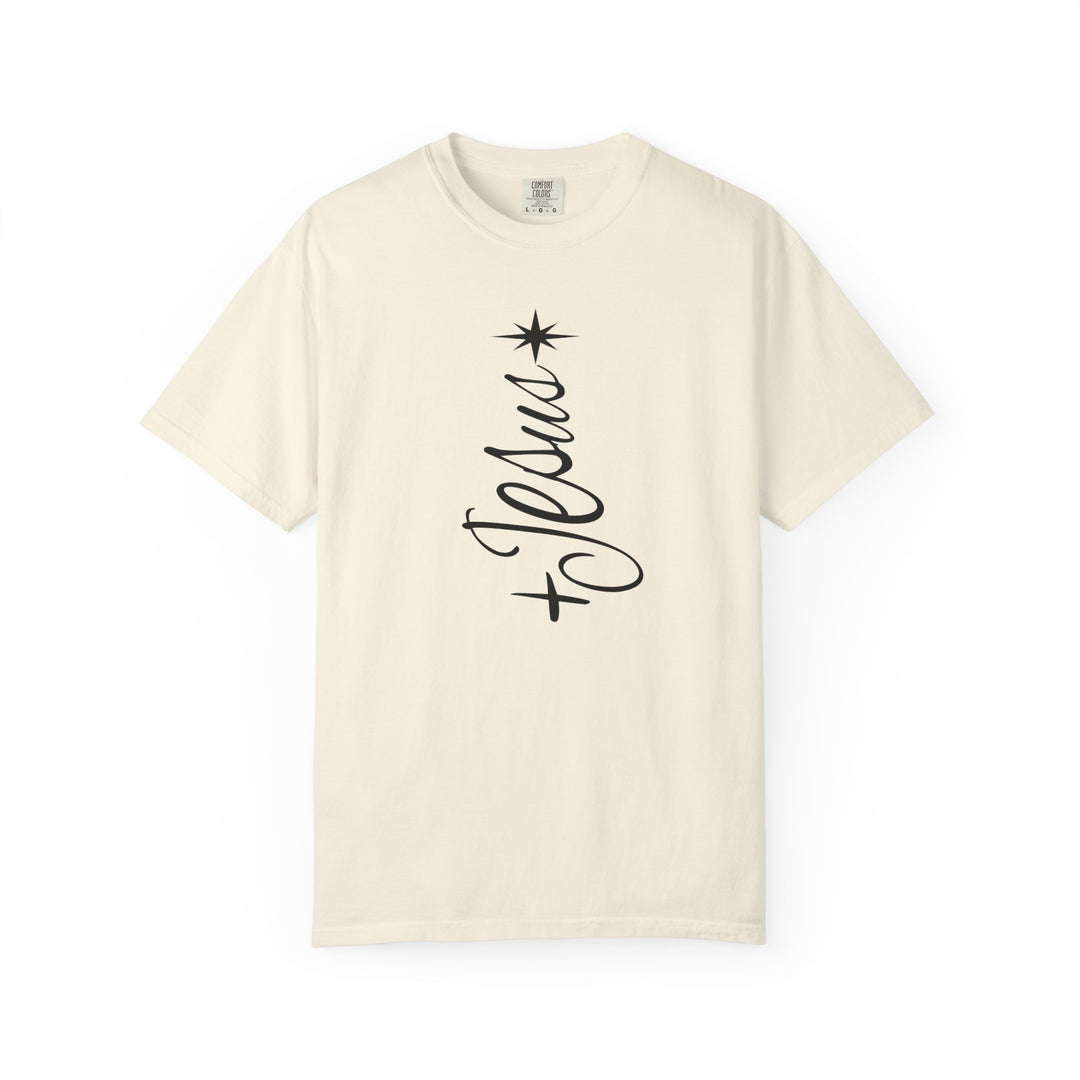 Cream-colored Jesus Tree Tee with a vertical Jesus graphic, resembling a Christmas tree with an eight-pointed star on top. Short sleeves, minimalist design.