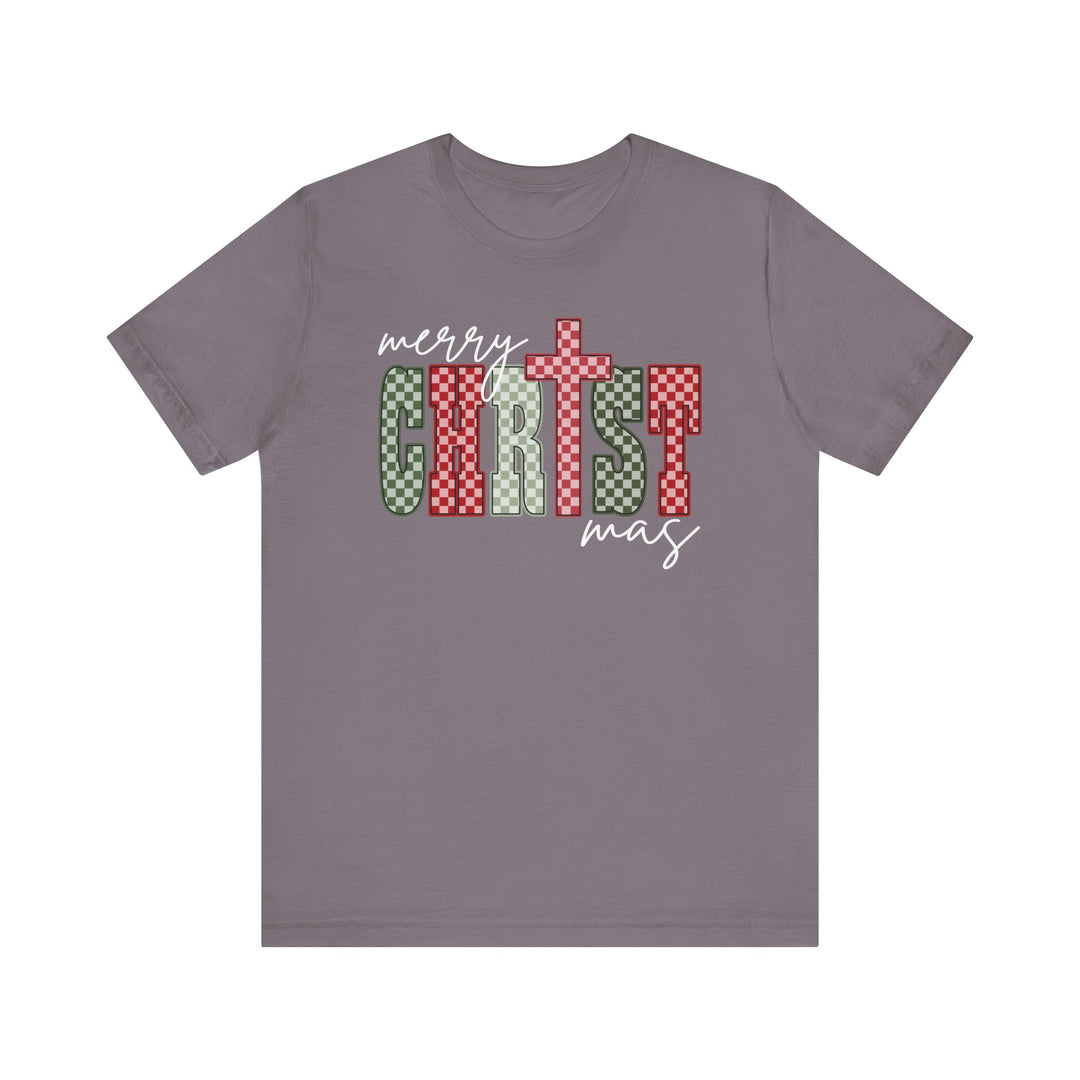 Christmas Tee with merry CHRISTmas design in festive checkerboard patterns on a soft, gray/purple short-sleeved shirt, featuring a cross-stylized T.