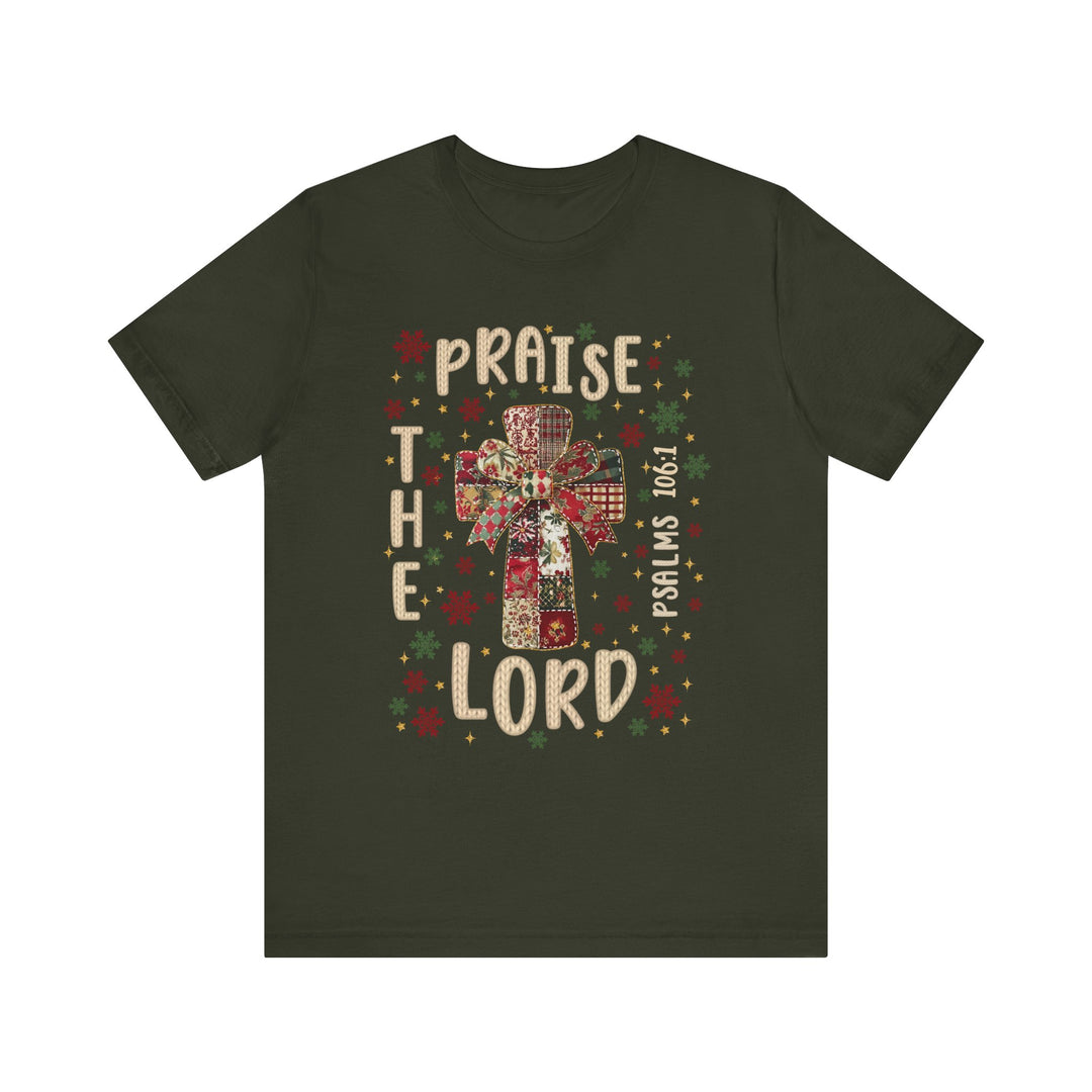 Dark-green Praise the Lord Tee with gift-wrapped cross graphic, snowflakes, stars, and Psalms 100:1 citation, offering a cozy, soft cotton fit.