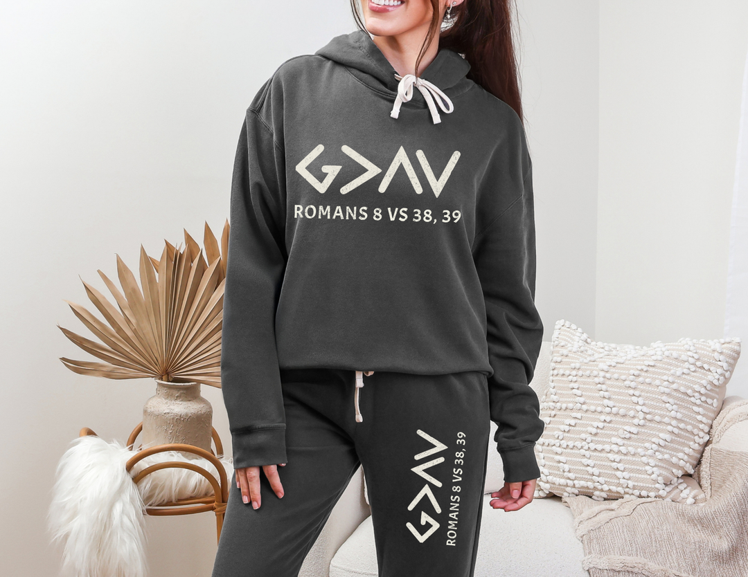 Woman wearing God is Greater Sweatpants, relaxed fit, 100% ring-spun cotton, vintage vibe, garment-dyed for retro look. Part of Worlds Worst Tees collection.