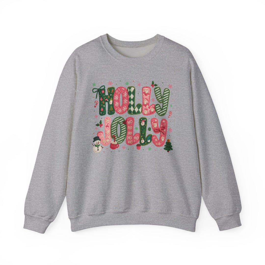 Light-gray sweatshirt with “HOLLY JOLLY” in festive letters, surrounded by Christmas motifs like snowflakes and holly, embodying cozy holiday spirit.