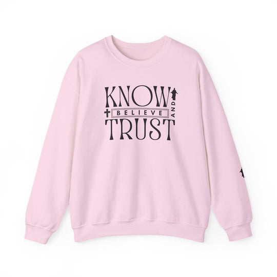 Pink crewneck sweatshirt with black text, Trust, Know, Believe, featuring a casual design perfect for cooler months with durable stitching and a comfortable fit.