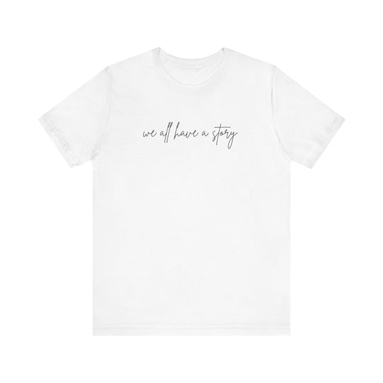 We all have a Story Tee featuring bold black text on a white t-shirt, classic unisex fit with ribbed knit collar and tapered shoulders.