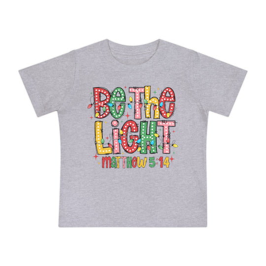 Be the Light Baby Tee: Light-heather-gray children's T-shirt featuring 'Be the Light' graphic with colorful Christmas bulbs and 'Matthew 5:14' reference, combining style and comfort.