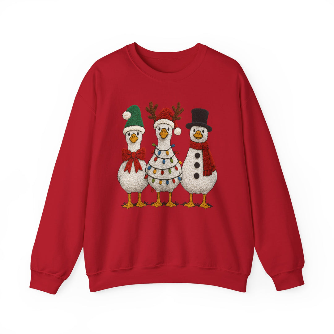 Red crew-neck sweatshirt featuring three cartoon geese dressed for Christmas: one in a Santa hat, another with antlers, and the third as a snowman.