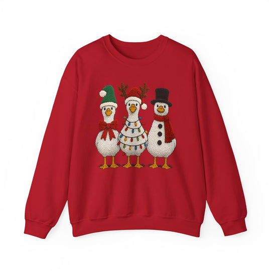 Red crew-neck sweatshirt featuring three cartoon geese dressed for Christmas: one in a Santa hat, another with antlers, and the third as a snowman.