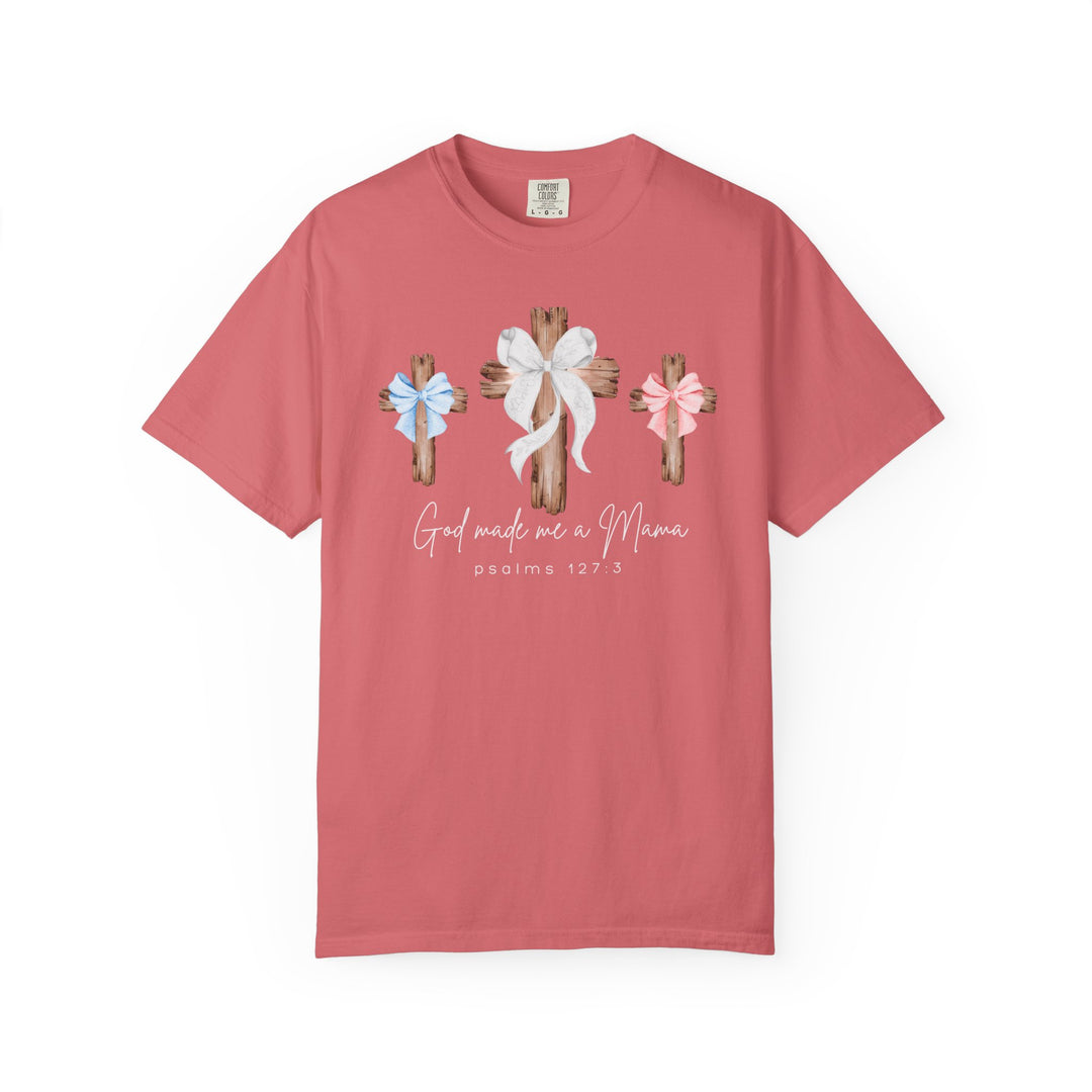 Coral Comfort Colors T-shirt featuring three rustic crosses with bows and the text God made me a Mama and psalms 127:3 beneath, from Faith Family Designs.