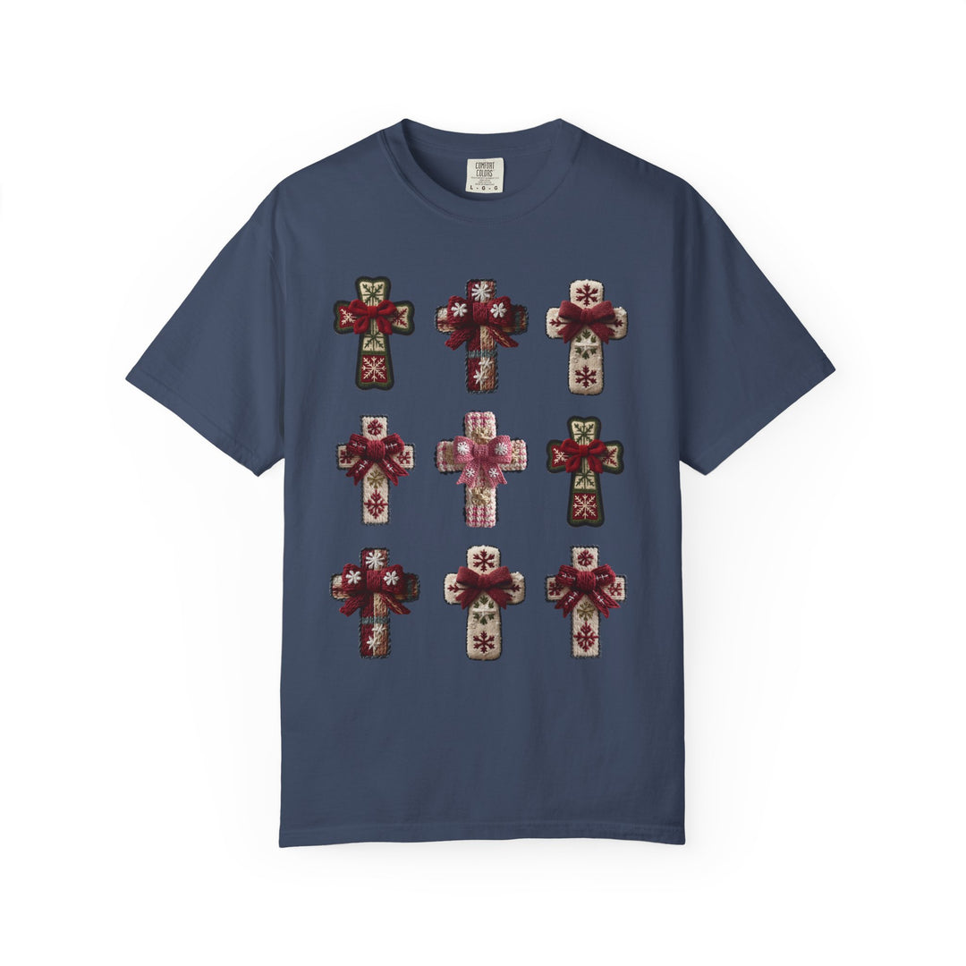 Navy-blue Crosses Tee featuring a 3×3 grid of stylized, knitted-look crosses with snowflake motifs and small bows, offering a cozy, winter-themed design.