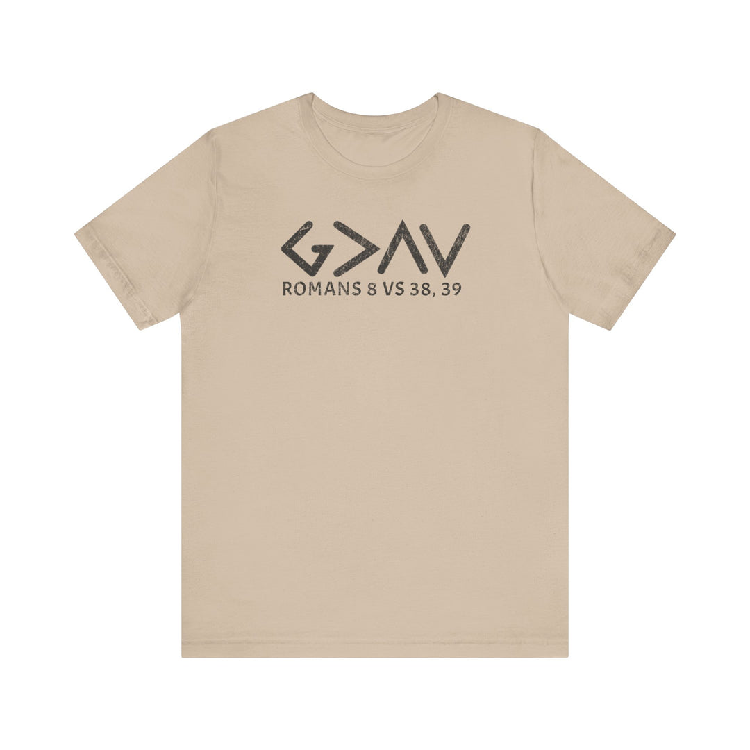 God is Greater Tee features bold black text on a tan t-shirt, offering a classic unisex fit with soft cotton and durable construction.