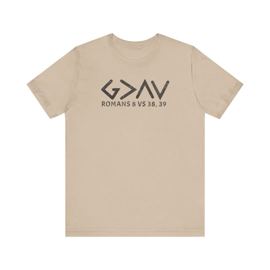 God is Greater Tee features bold black text on a tan t-shirt, offering a classic unisex fit with soft cotton and durable construction.