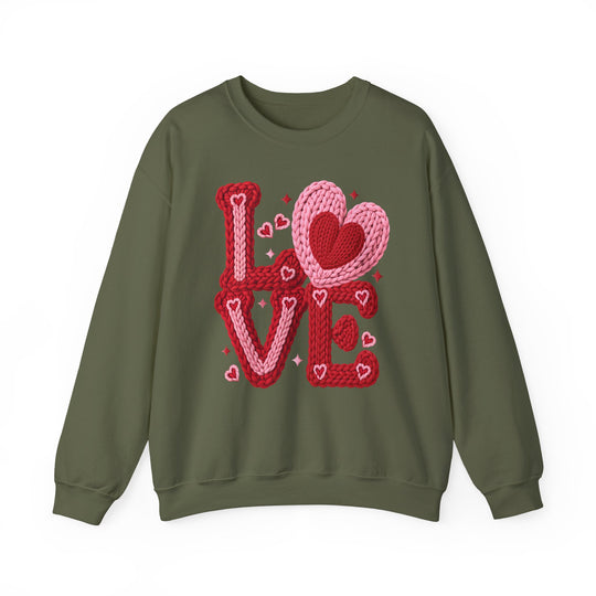 Olive-green crewneck sweatshirt with a LOVE graphic, featuring interlocking heart motifs, designed by Faith Family Designs for a playful, Valentine’s-inspired look.
