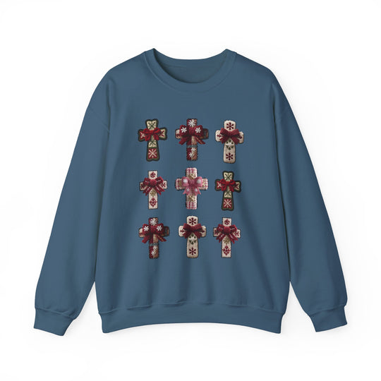 Blue crew-neck sweatshirt with a 3×3 array of festive cross motifs, each featuring snowflake patterns and bows, offering a handcrafted, cozy look.