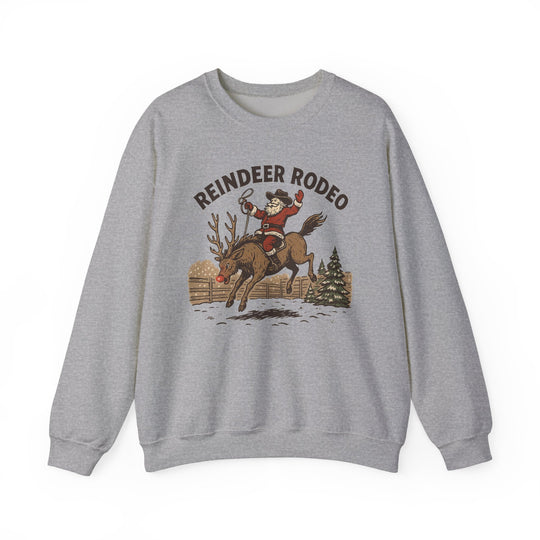 Light-heather gray sweatshirt featuring a Reindeer Rodeo design with Santa riding a reindeer, showcasing festive, humorous holiday spirit in a cozy, durable crewneck style.