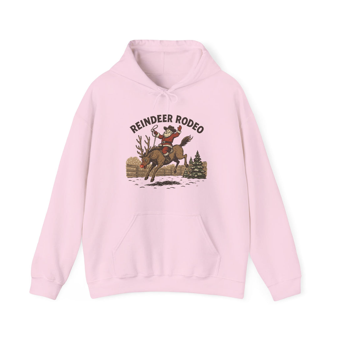 Light pink Reindeer Rodeo Hoodie featuring Santa on a reindeer in a snowy setting, with kangaroo pocket and color-matched drawstring for cozy, stylish warmth.