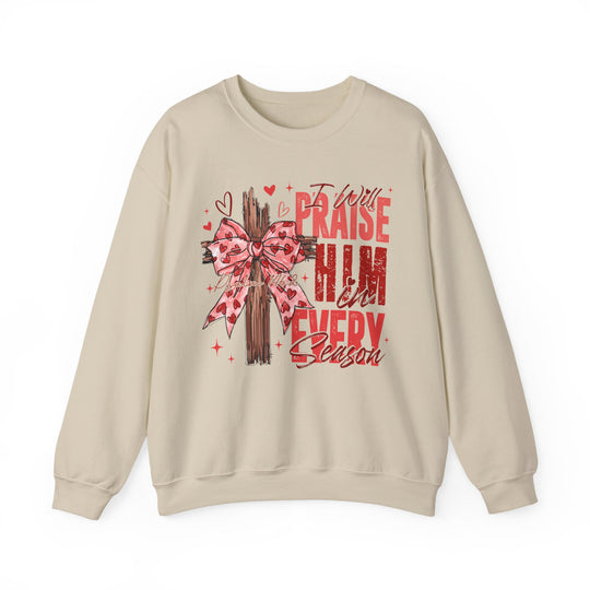 Praise in Every Season Heart Crew: Light-beige crewneck sweatshirt with wooden cross design, pink bow, tiny hearts, sparkles, and inspirational Psalm 146:2 message.