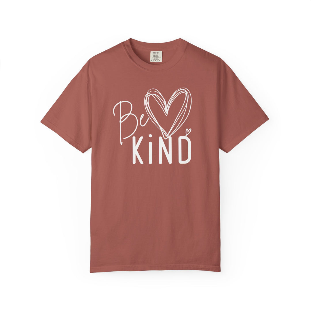 Be Kind Tee featuring a white graphic with heart accents on a rust T-shirt, offering luxurious comfort with a relaxed fit and soft fabric.