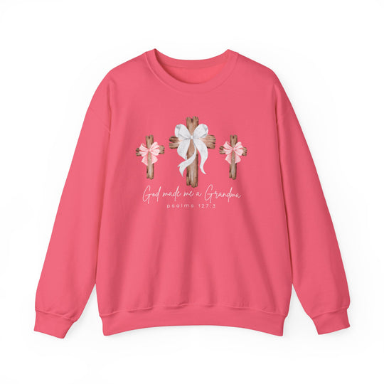 God Made Me a Grandma Crew: Pink sweatshirt featuring rustic wooden crosses with bows and scriptural text, offering comfort with a cotton-polyester blend and ribbed collar.