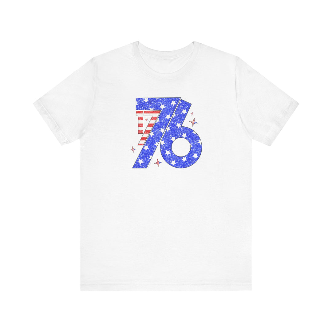A white 1776 Tee with a red and blue design, featuring stars and stripes. Unisex jersey tee made of 100% Airlume combed cotton, retail fit, tear away label. Sizes XS to 3XL.