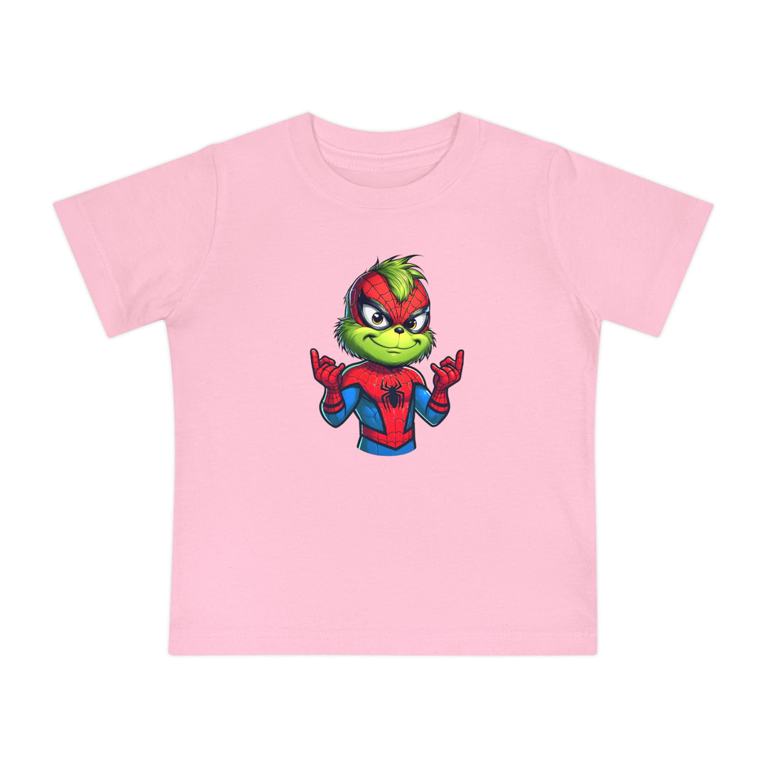 Spider Baby Tee: Light-pink toddler T-shirt featuring a cartoon mix of the Grinch and Spider-Man, showcasing the Grinch in a Spider-Man suit making web-shooter gestures.