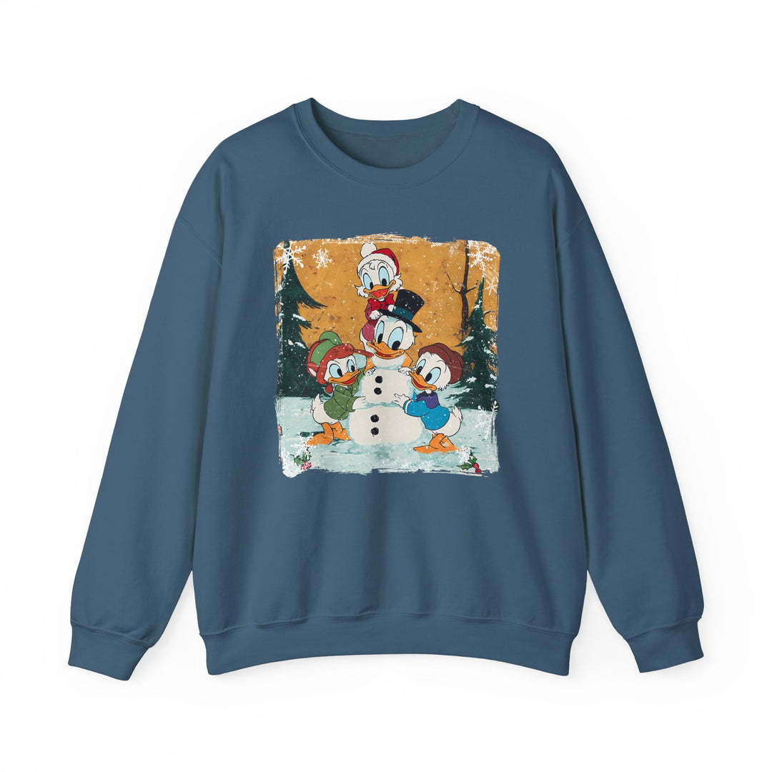 Blue crew-neck sweatshirt featuring Donald Duck and nephews building a snowman amidst snowy trees, capturing a playful winter scene. Cozy, medium-heavy fabric blend for comfort.