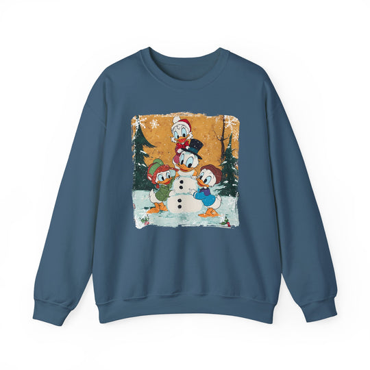 Blue crew-neck sweatshirt featuring Donald Duck and nephews building a snowman amidst snowy trees, capturing a playful winter scene. Cozy, medium-heavy fabric blend for comfort.