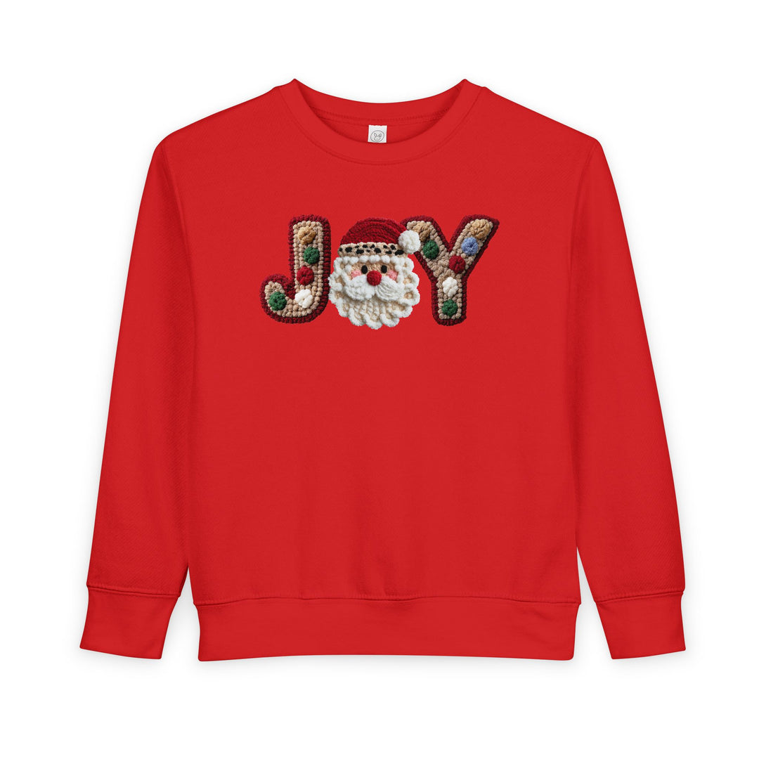 Joy Toddler Crew sweatshirt features JOY with a Santa face and pom-pom details on red fleece, offering warmth and style for toddlers.
