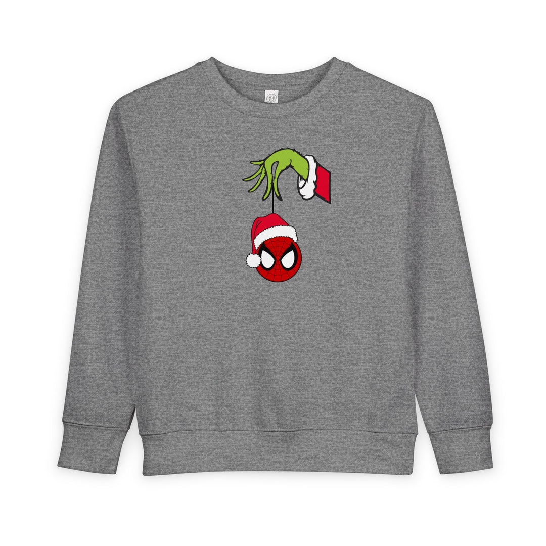 Spider Ball Christmas Toddler Crew sweatshirt featuring Grinch holding Spider-Man mask ornament, offering cozy comfort with its soft cotton-poly blend.