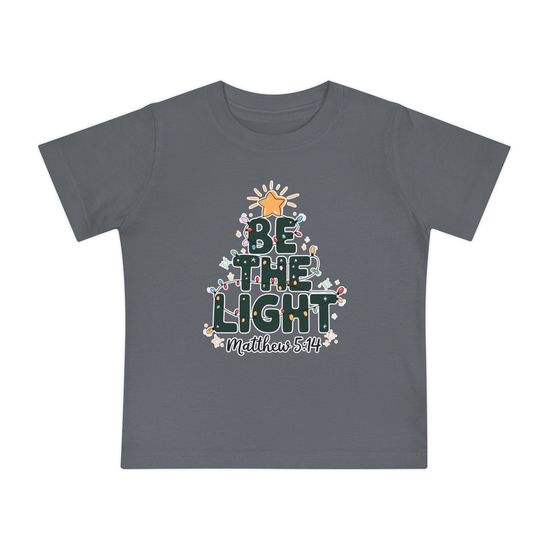 Be the Light Baby Tee: Dark-gray kids' T-shirt with BE THE LIGHT Christmas tree graphic and Matthew 5:14 beneath, made from soft, durable cotton.