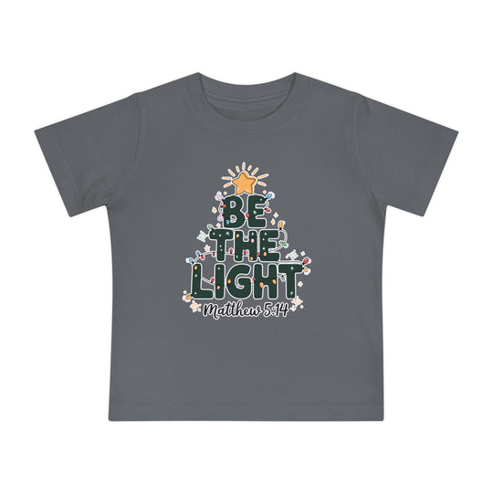 Be the Light Baby Tee: Dark-gray kids' T-shirt with BE THE LIGHT Christmas tree graphic and Matthew 5:14 beneath, made from soft, durable cotton.