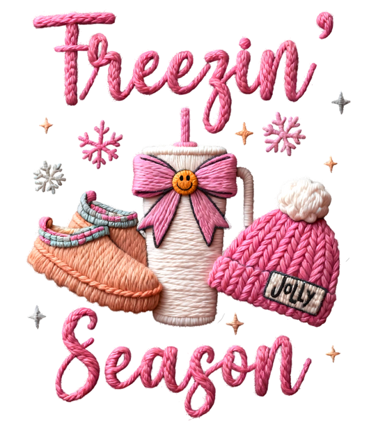 Freezin Season Kids Tee: Embroidered-style illustration of a to-go mug, slippers, and beanie, encapsulated in cozy winter themes with Freezin’ Season text. Perfect for everyday use.