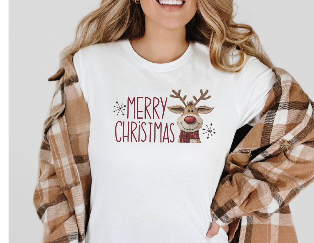 Merry Christmas Reindeer Tee: A festive white T-shirt with red lettering, snowflakes, and a reindeer graphic, layered under a brown-and-cream plaid shirt.