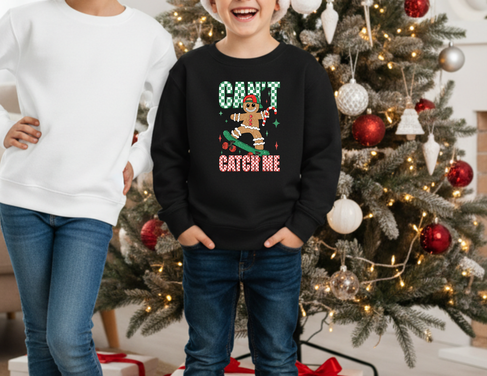 Two kids by a Christmas tree; right child wears Can't Catch Me Toddler Crew with skating gingerbread graphic, showcasing festive and playful design.