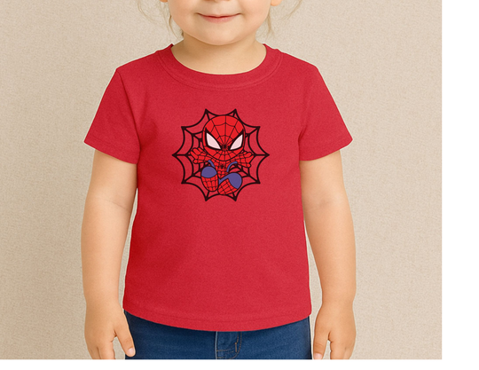 Child wearing Spider Kid Kids Tee featuring a cartoon-style spider-hero face and web design, paired with blue jeans, highlighting a playful, durable, cotton-rich fabric.