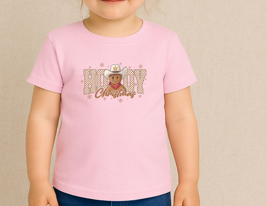Child wearing Howdy Christmas Baby Tee with a gingerbread cowboy design, showcasing a blend of festive cheer and Western style.