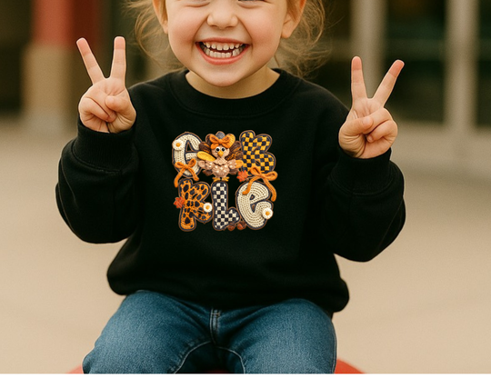 Child wearing Gobble Toddler Crew sweatshirt with fall-themed design, featuring crochet-style letters and cartoon turkey, showcasing cozy and stylish toddler apparel by Faith Family Designs.