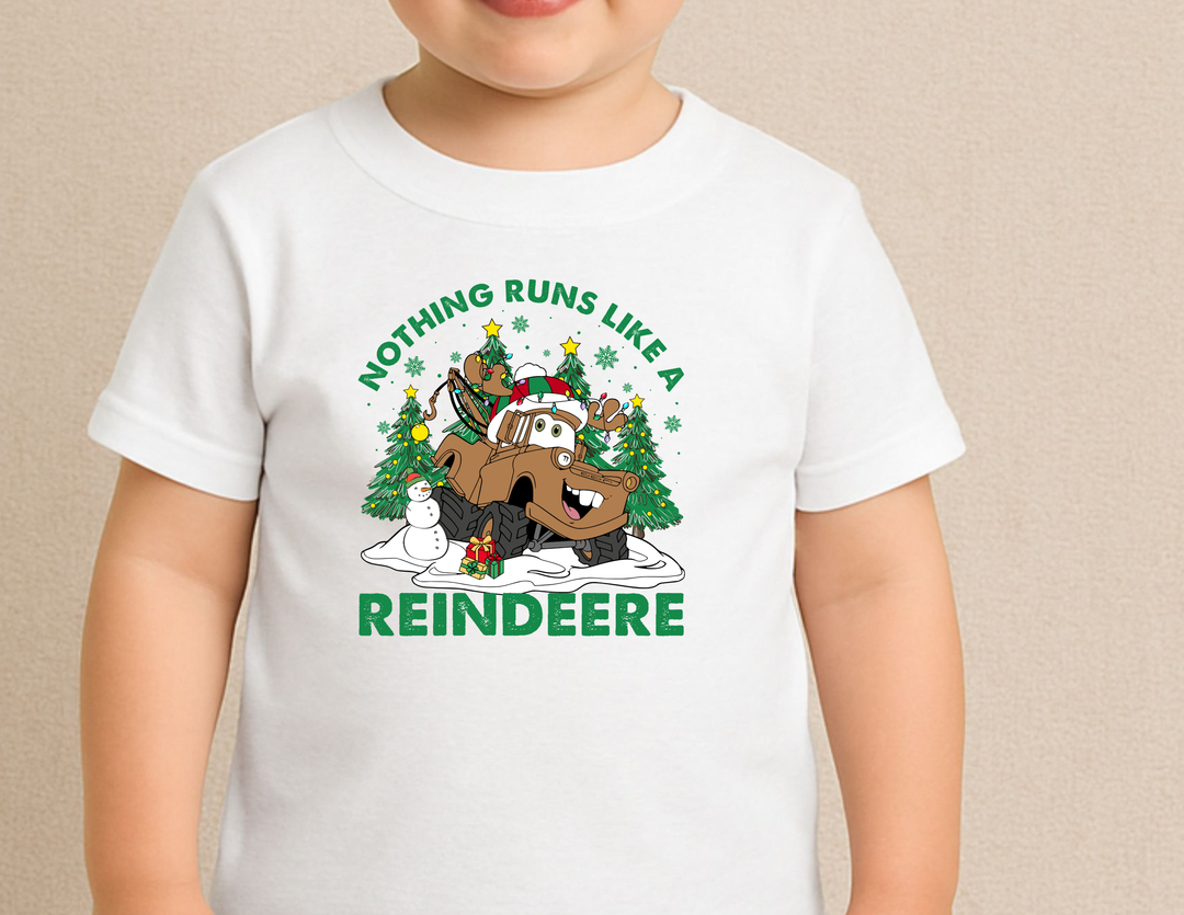 Reindeere Toddler Tee features a festive cartoon truck as a reindeer with a snowman, gift, and Christmas trees, ideal for sensitive skin.
