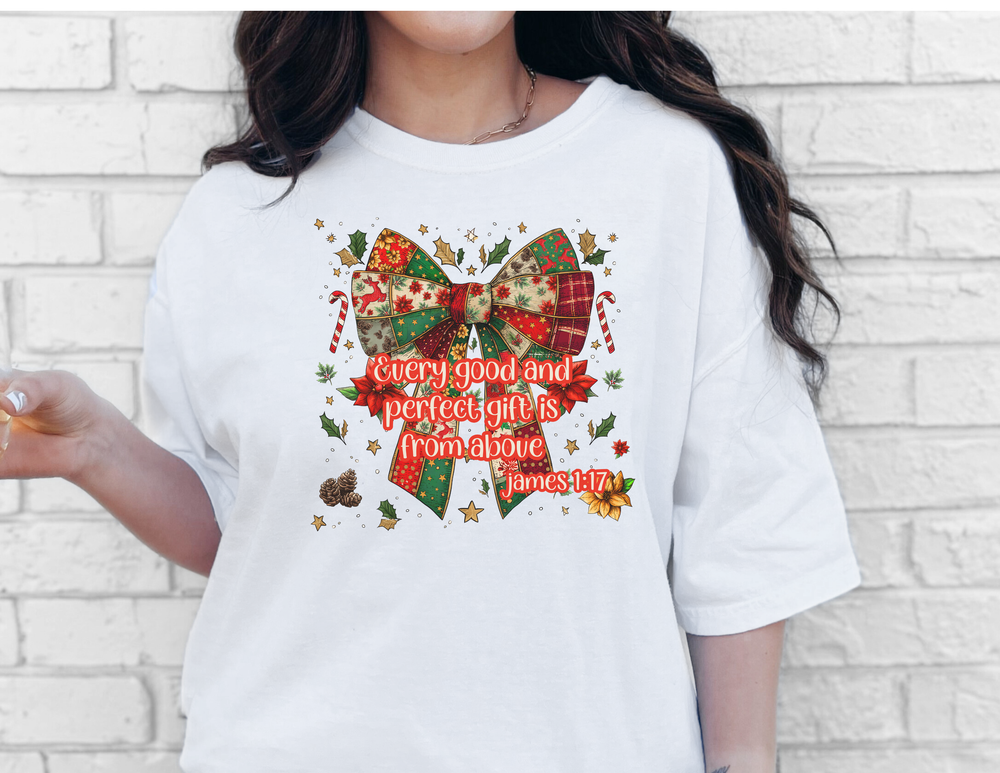 Gift from Above Tee featuring a patchwork Christmas bow with holly, pinecones, and Bible verse, on a soft, unisex cotton T-shirt.