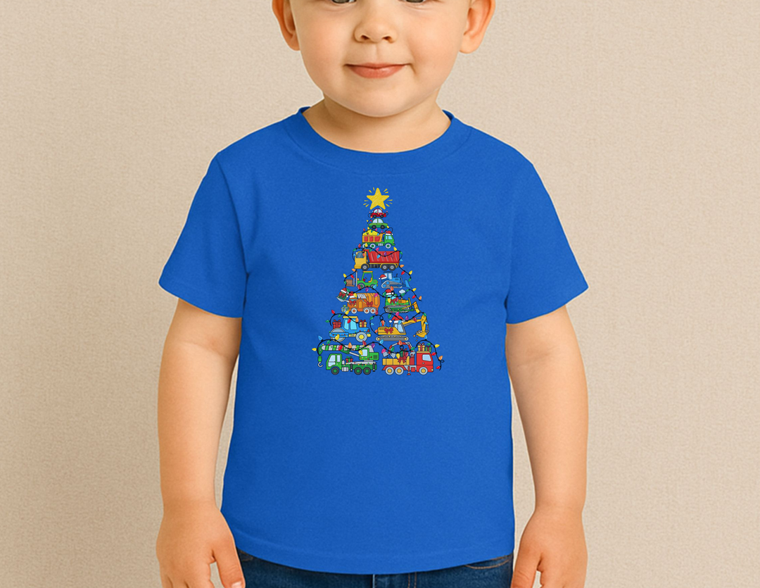 Toddler wearing a royal-blue Christmas Truck Baby Tee featuring a festive construction vehicle stack shaped like a Christmas tree with lights and star.