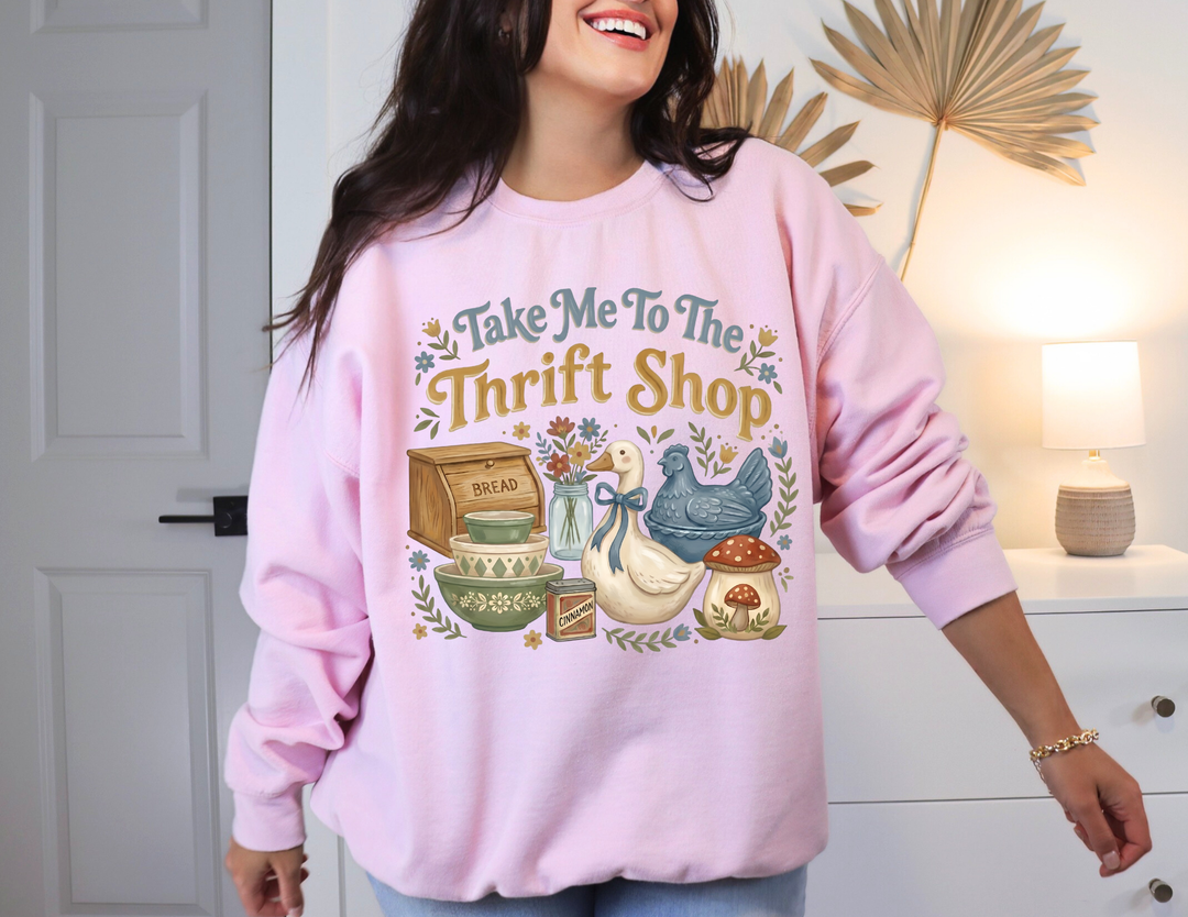 Person wearing 'Take Me To The Thrift Shop' crewneck with whimsical thrift motifs, showcasing cozy, unisex design by Faith Family Designs.