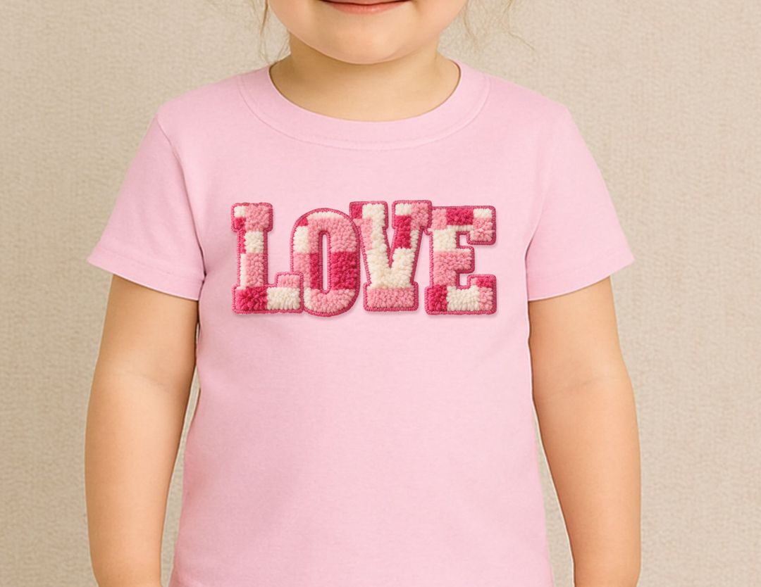 Child wearing the Love Toddler Tee, featuring plush-textured LOVE letters, ideal for toddlers with its soft, durable cotton fabric and classic fit.