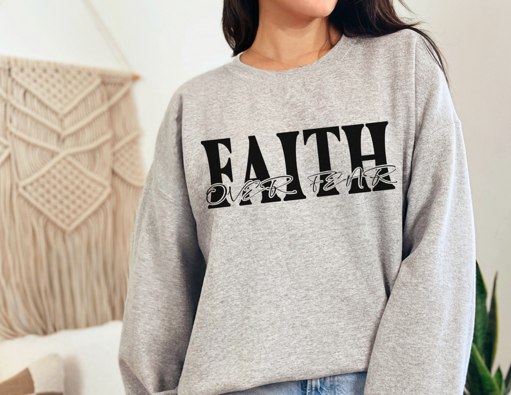 Faith Over Fear Crew sweatshirt, worn by a woman, featuring a ribbed knit collar, medium-heavy fabric, and no side seams for comfort.