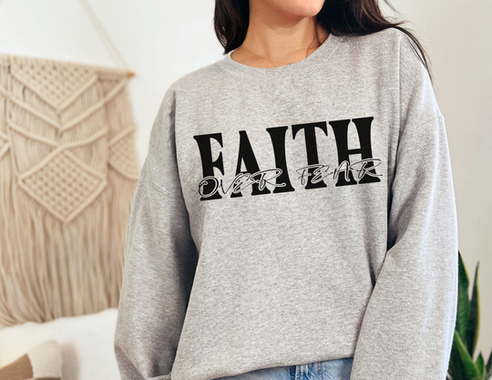 Faith Over Fear Crew sweatshirt, worn by a woman, featuring a ribbed knit collar, medium-heavy fabric, and no side seams for comfort.