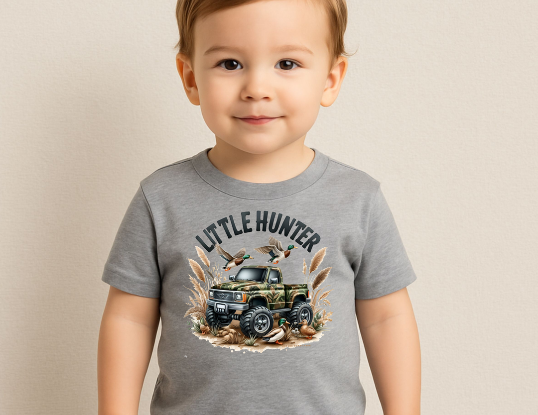 Little Hunter Toddler Tee features a camo-painted truck with mallard ducks, perfect for kids' adventures. Soft, durable cotton ideal for sensitive skin.